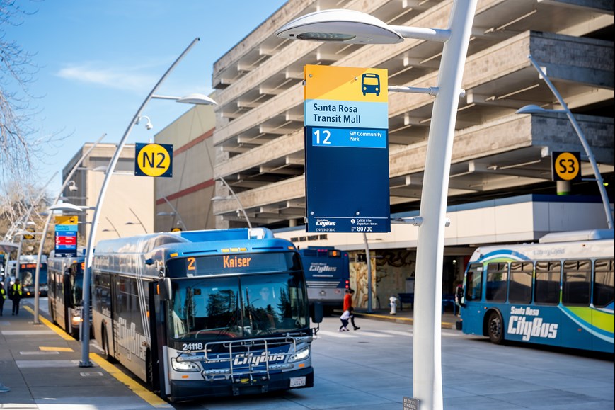 New bus bay and bus flag signs with two Santa Rosa City Buses at the Santa Rosa Transit Mall.